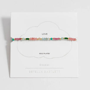 Multicolored beaded bracelet on a white card with brand name