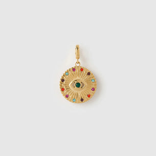 Gold pendant with colorful stones on a light gray background