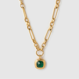 Gold chain necklace with a green gemstone pendant on a white background