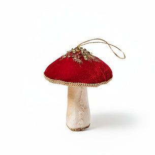 Decorative mushroom ornament with red velvet cap and beige stem on a white background