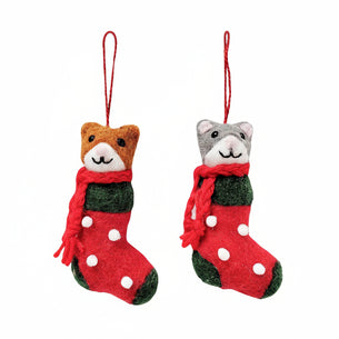 Two cat-shaped Christmas stockings with scarves on a white background