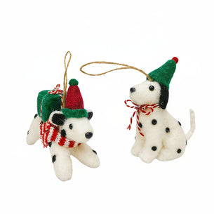 Two festive dog ornaments with hats and scarves on a white background