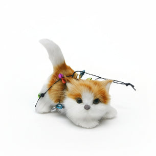 Plush cat toy with string lights on a white background